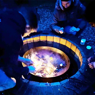 Enjoying a cup of hot chocolate round the camp fire